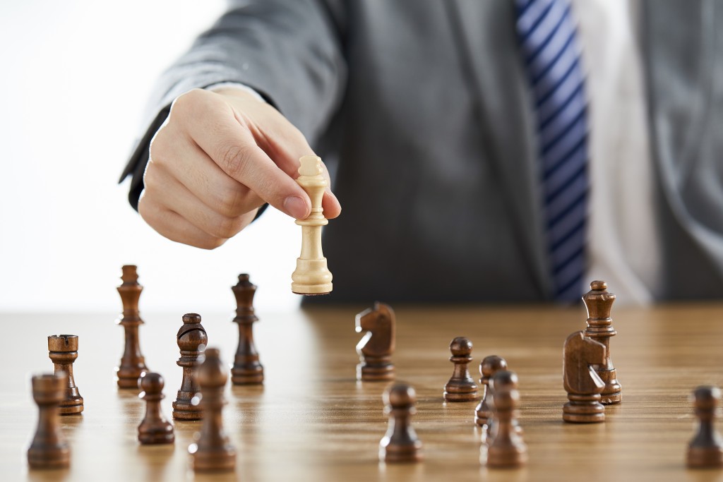 businessman-suit-using-his-white-king-chess-piece-dark-chess-pieces-table.jpg